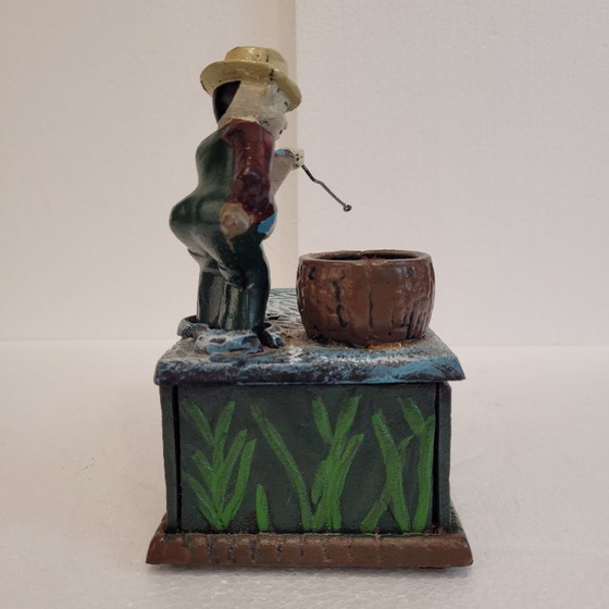 Image 1 of "Fisherman" piggy bank with fishing mechanism, cast iron, 1950s - USA.