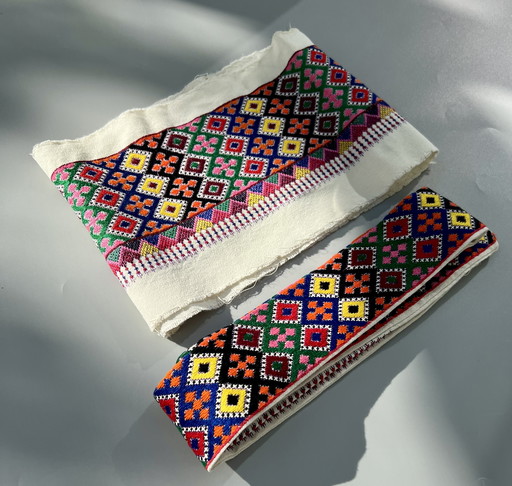 Two Hungarian borders with colorful hand embroidery with a folkloristic pattern