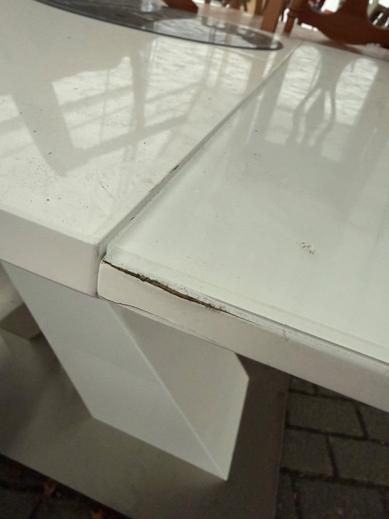 Image 1 of Contemporary white wooden dining table with stainless steel details and a 40 cm folding tabletop section