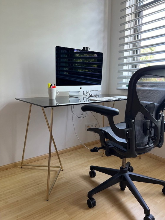 Image 1 of MADE  black smokey glass desk with golden metal legs