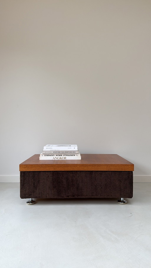 Coffee table with brown rub fabric, wooden top and chrome legs