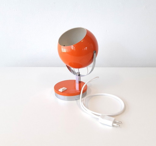 Vintage graphic orange metal eyeball table lamp, space age lampVintage graphic orange metal eyeball table lamp, space