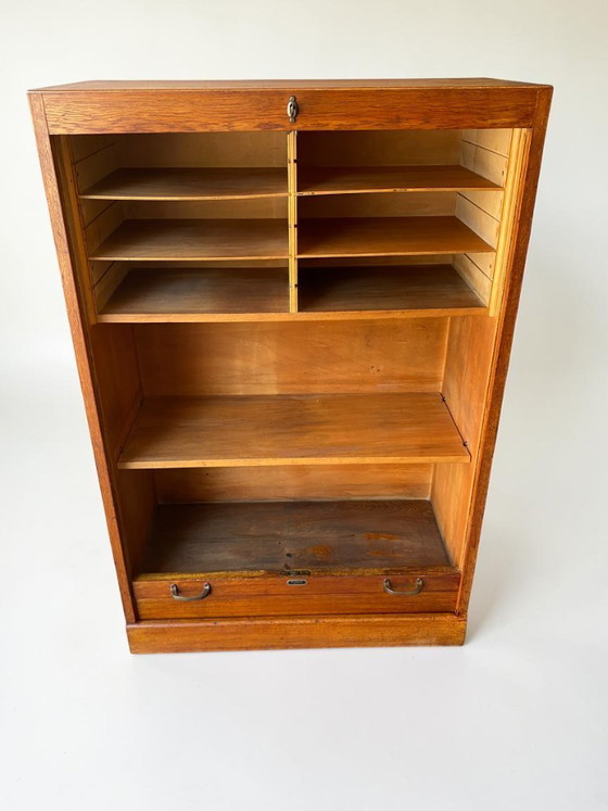 Image 1 of Antique German oak roll-top wardrobe with original key and working wooden roll-top. Made around 1920–1935