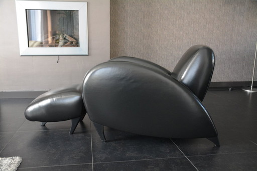 Designer armchair with footstool