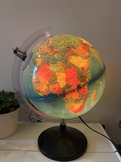 Globe with light and magnifying glass