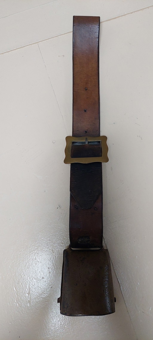 Antique cowbell with leather strap