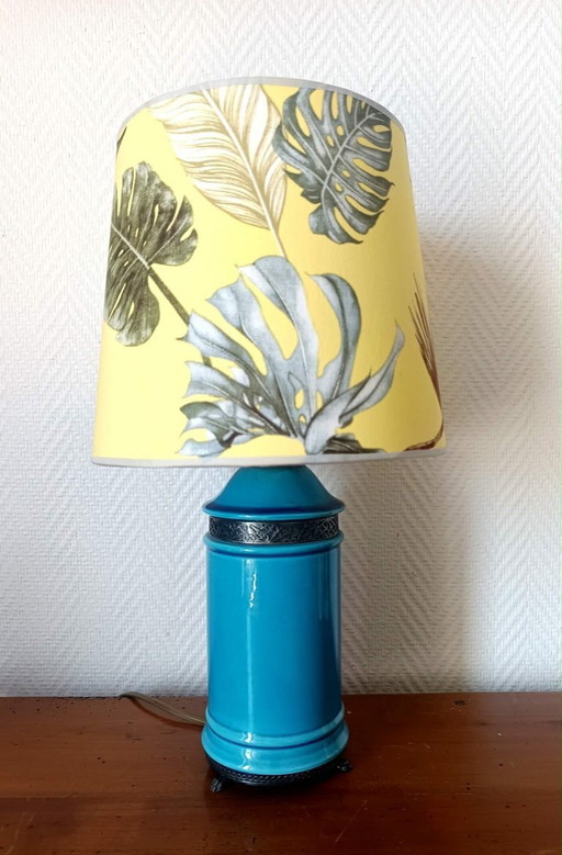 Blue ceramic lamp with claw feet and foliage lampshade