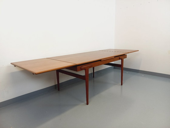 Image 1 of Vintage Scandinavian rectangular dining table by Ejvind A. Johansson from the 50s and 60s in teak with integrated extensions