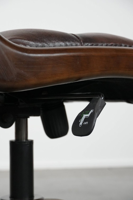 Image 1 of English-style Chesterfield office chair made of cowhide and wood on wheels