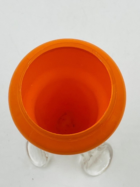 Image 1 of Vintage orange glass bud vase with a sculpted base