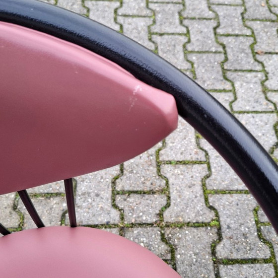 Image 1 of This is a set of four vintage 'Memphis' style chairs with a black metal frame and burgundy upholstery.