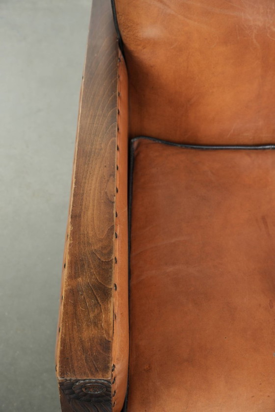 Image 1 of Unieke schapenleren art Deco fauteuil met mooi houtsnijwerk en zwarte biezen