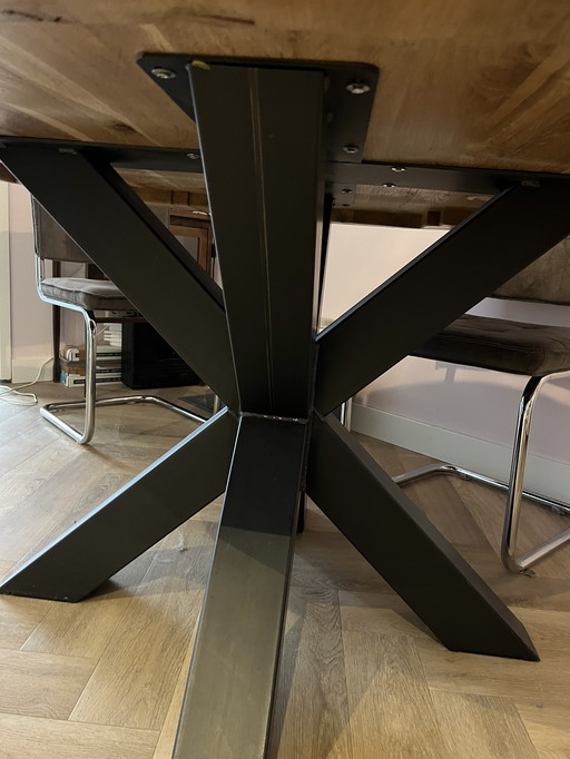 Round oak wooden dining table with industrial steel legs