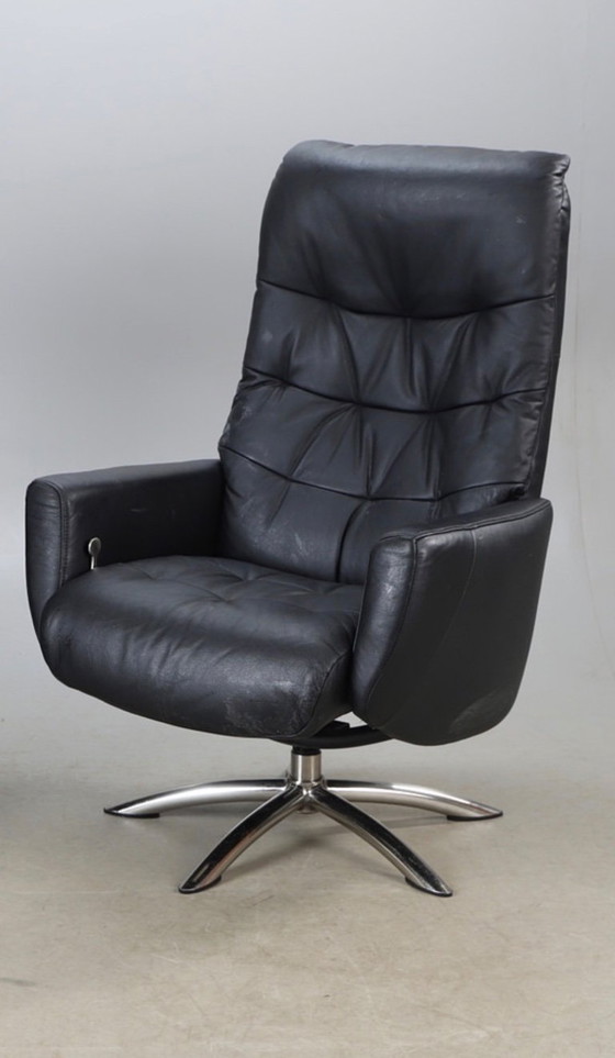 Image 1 of Modernist black leather armchair with a chrome X-frame base in a contemporary style, in good condition with minor signs of aging