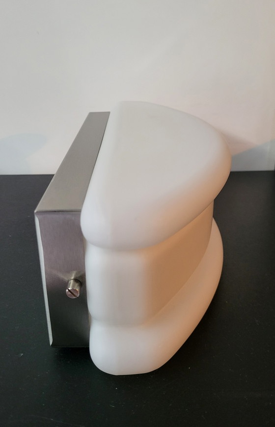 Image 1 of 3 RAAK (bathroom) wall lamps with opaline glass shade and stainless steel frame.