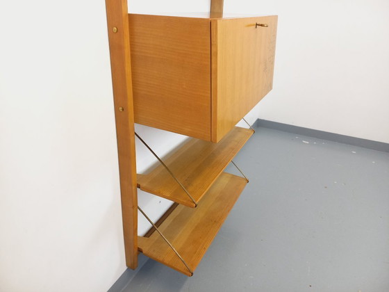 Image 1 of Wall-mounted bookcase with vintage light wood and brass secretary bar, dating from the 1960s