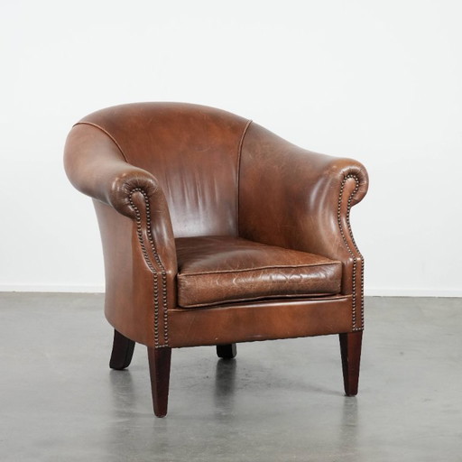 cognac-colored vintage cowhide club armchair in English style