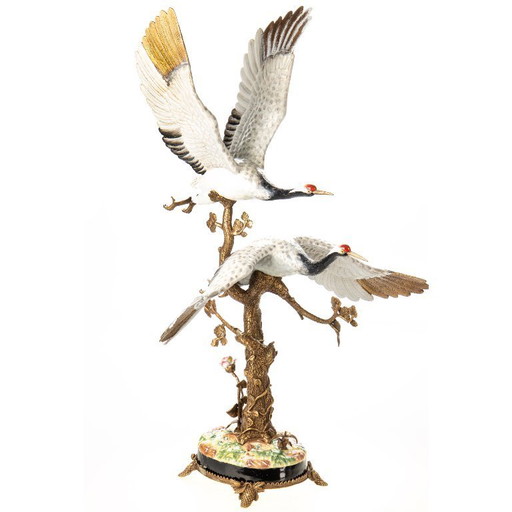Kraanvogels van porselein en brons