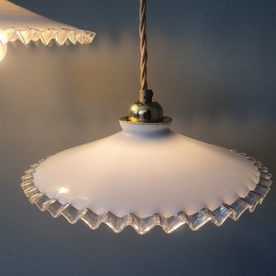 Image 1 of 2 vintage hanglampen van wit opaline glas met een transparante sierrand.