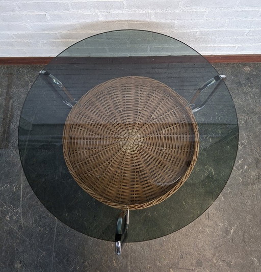 vintage round coffee table with glass top and wicker magazine basket