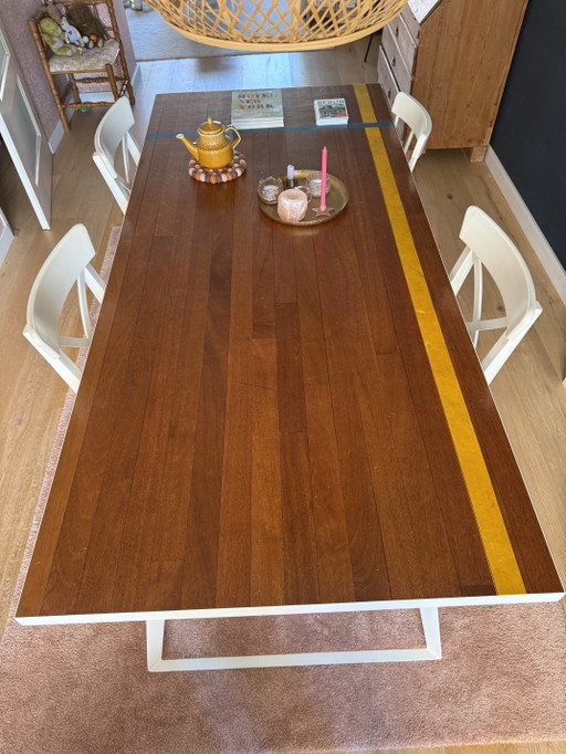 Unique dining table with a top made from vintage gymnasium flooring