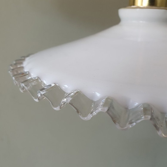 Image 1 of 2 vintage hanglampen van wit opaline glas met een transparante sierrand.