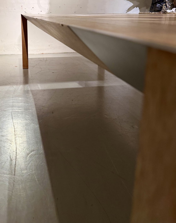 Image 1 of A large oak dining table, designed by Claire Bataille and Paul Ibens