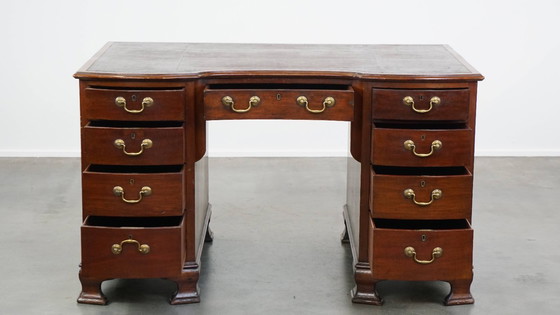 Image 1 of Luxurious and antique English wooden desk from the late 19th century with a leather top and a curved front.