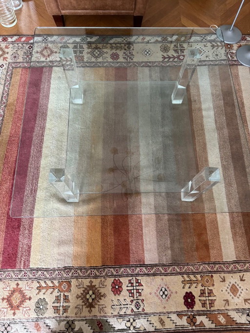 Sleek glass coffee table with plexiglass legs