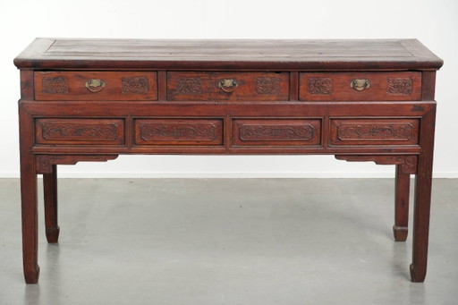 Antique wooden Chinese sideboard from the late 19th century in a beautiful red color with exquisite wood carving.