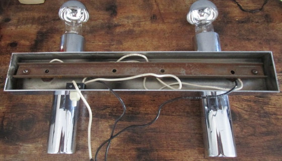 Image 1 of This chrome-colored space-age wall lamp is attributed to designer Gaetano Sciolari from the 1970s.