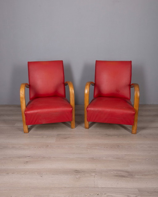Coppia di poltrone vintage anni '50 in pelle rossa, design italiano.