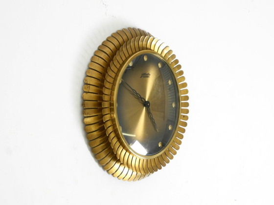 Image 1 of Beautiful original Mid Century Sunburst Atlanta Universe wall clock made of heavy brass with a mechanical seven-day movement