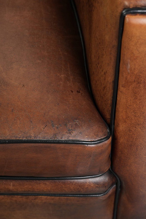 Image 1 of 2x schapenleren Art Deco design clubfauteuil met een mooi patina, zwarte biezen en mooie kleuren