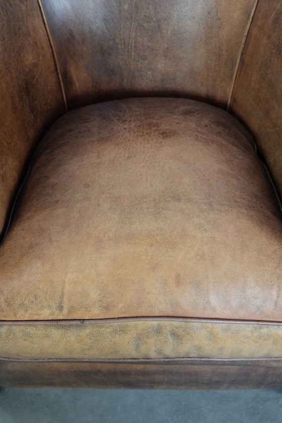 Image 1 of Clubfauteuil gemaakt van schapenleer afgewerkt met siernagels