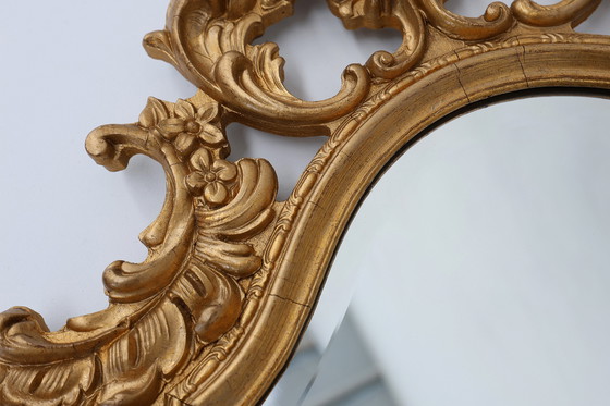 Image 1 of French Rococo or Baroque style facet-cut crest mirror in gilded carved wood