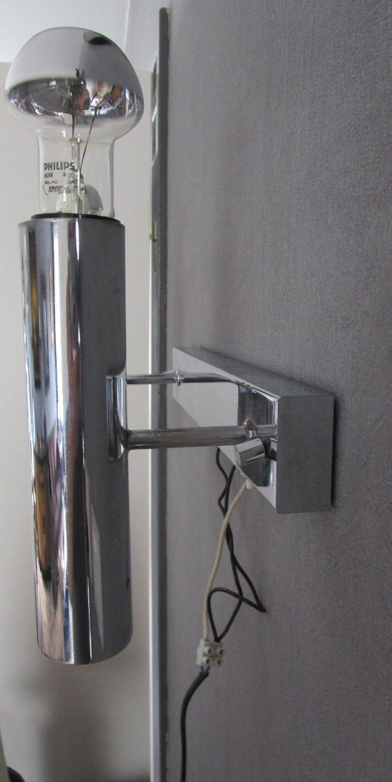 Image 1 of This chrome-colored space-age wall lamp is attributed to designer Gaetano Sciolari from the 1970s.