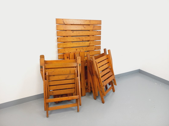 Image 1 of Vintage garden furniture consisting of a table with extensions and 4 wooden armchairs from the 60s