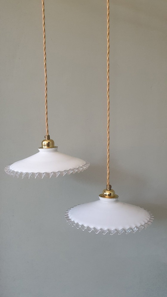 Image 1 of 2 vintage hanglampen van wit opaline glas met een transparante sierrand.