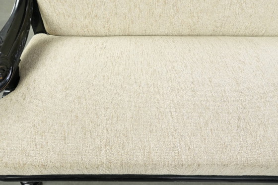 Luxurious 19th-century French sofa in Empire style with cream-colored fabric and uniquely detailed armrests. (photo 5 of 13)