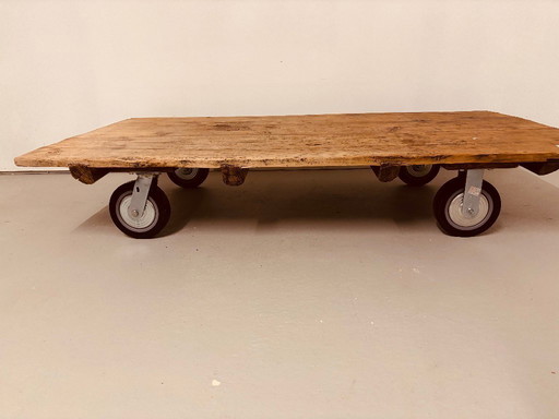 Antique, solid coffee table on castors