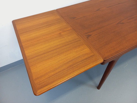 Image 1 of Scandinavian rectangular vintage dining table by Johannes Andersen for Samcom from the 60s in teak with integrated extensions