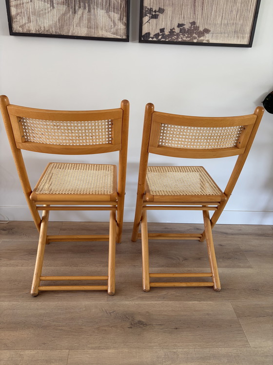 Image 1 of Twee vintage inklapbare houten met webbing stoelen 