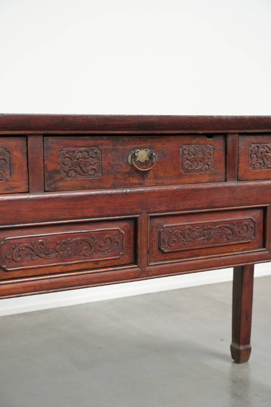 Image 1 of Antique wooden Chinese sideboard from the late 19th century in a beautiful red color with exquisite wood carving.