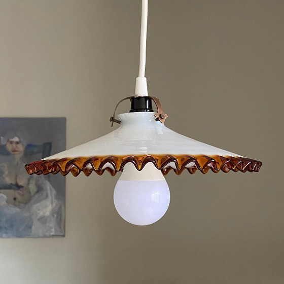 Image 1 of Antique pendant light with a white opaline glass shade and a golden caramel wavy edge