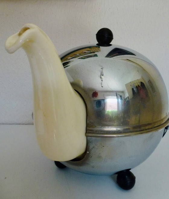 Image 1 of Ceramic Teapot with thermal Chrome casing which keeps the contents hot (or cold).