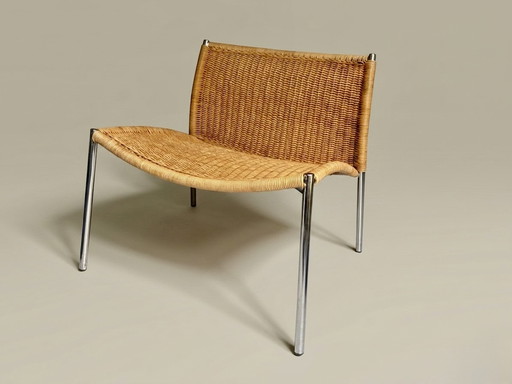 Vintage rattan lounge chair with chrome legs