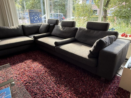 Corner sofa with footstool