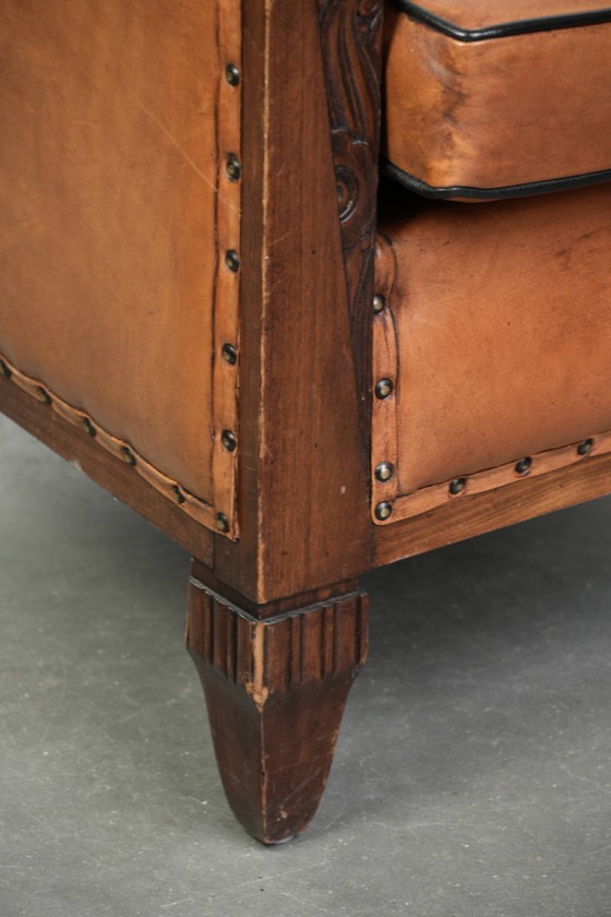 Image 1 of 2 x Prachtige schapenleren Art Deco fauteuil met mooi houtsnijwerk en zwarte biezen