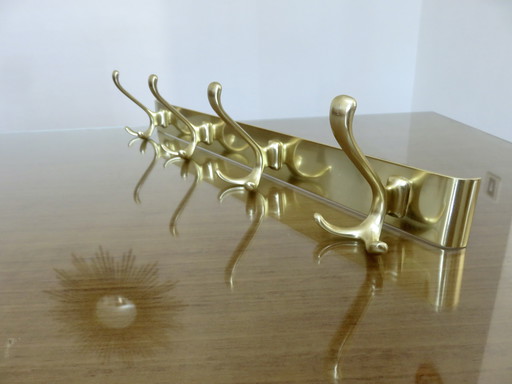 Large wall-mounted coat rack in gilded aluminum, France, 1970